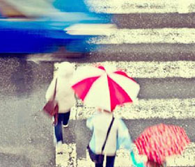 Paso de peatones con tres persona y un coche cruzando